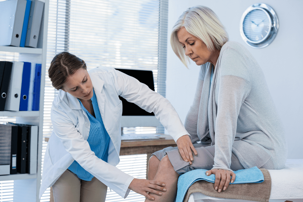 A patient with arthritis who needs treatment is being examined by a doctor